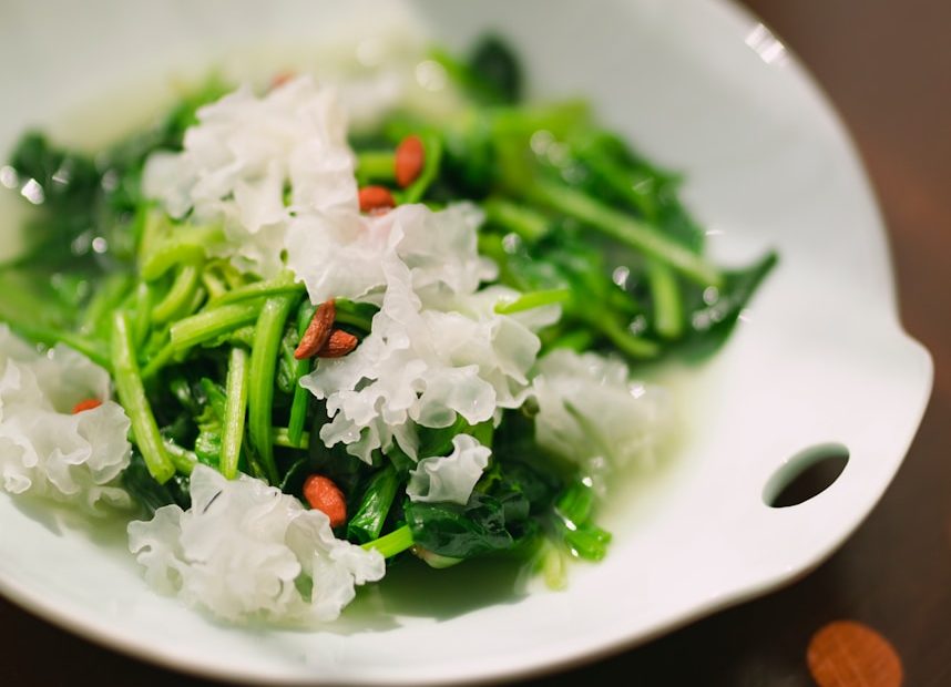 green vegetable on white ceramic plate
